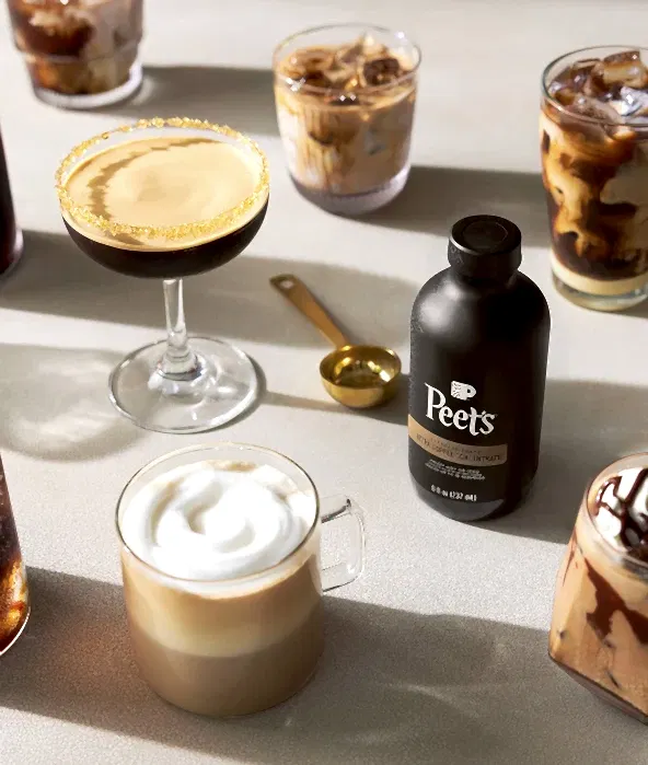 Peet's coffee bottle with various coffee drinks on a table